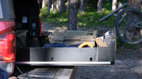 The Decked Drawer System is shown in the bed of a red pickup truck