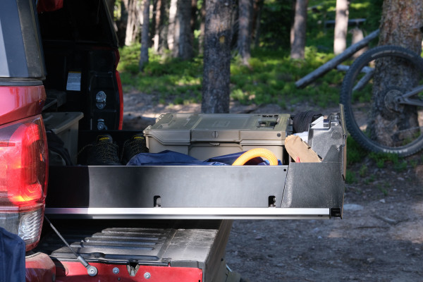 The Decked Drawer System is shown in the bed of a red pickup truck