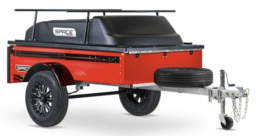 a SPACE travel trailer in red is shown in this product photo