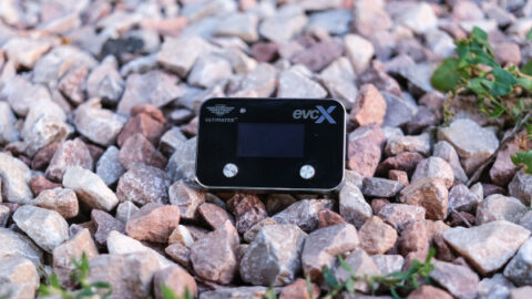 The Ultimate9 EVCX Throttle Controller is shown against granite stones