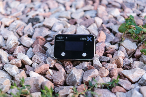 The Ultimate9 EVCX Throttle Controller is shown against granite stones