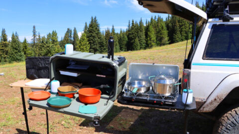 A silver truck is shown with Yakima EXO SwingBased OpenRange Deluxe Kitchen with Gerber plates and bowls