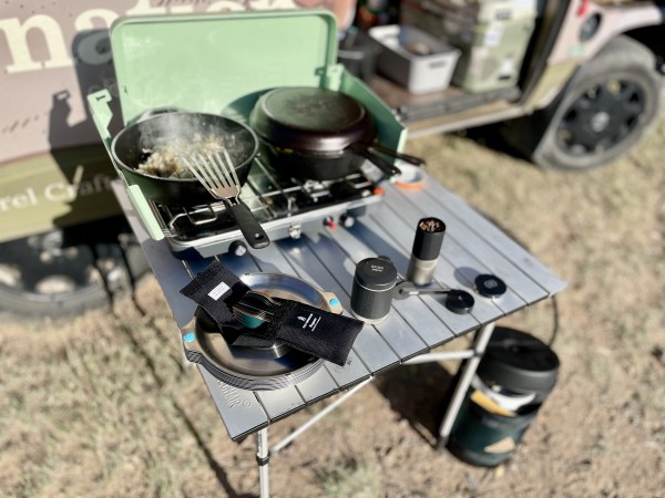 The Full Windsor Magware family cookware set is shown on a camp stove setup