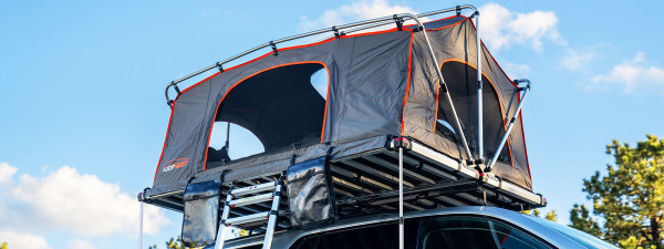 Meadowlark XL Roofnest car-top tent in gray with orange trim is shown, set up with the windows open.